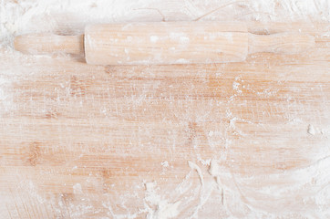 Rolling pin on a wooden tray covered with flour - Powered by Adobe