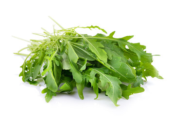 Sweet rucola salad or rocket lettuce leaves isolated on white ba