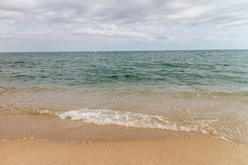 Fototapeta na wymiar View of the sandy beach of the sea coast of Spain