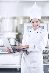 Female Chef Using Laptop