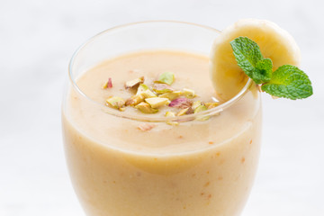 banana smoothie in a glass, closeup