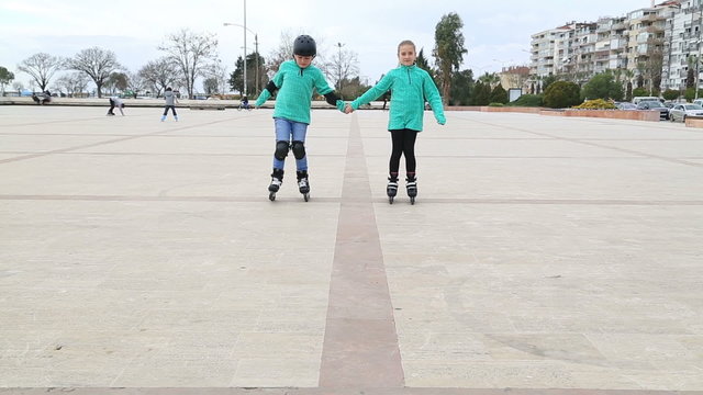 Portrait of a playful young skaters skating together