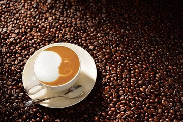 Cup of latte art, coffee and coffee beans