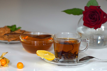 Transparent cup of tea with honey
