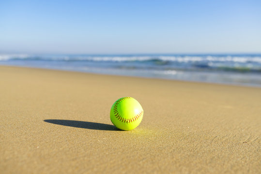 Softball at a California beach with white wave in pacific ocean