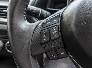Control buttons on steering wheel. Car interior.