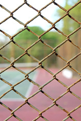 cage of blurred tennis court