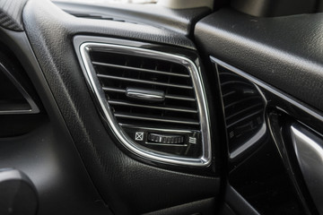 Detail with the air conditioning button inside a car.