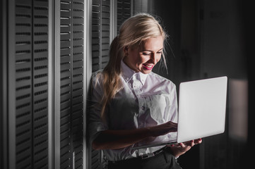 Young engineer businesswoman in server room