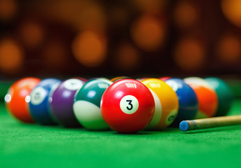 Billiard balls in a green pool table