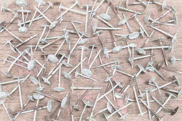 Old grunge rusty nails on vintage wooden background in vintage s