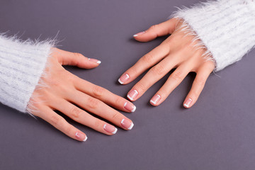 Sleeves of fluffy sweaters and lunar french manicure.