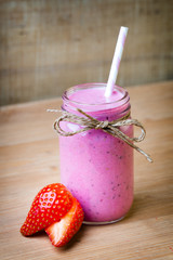Smoothie, pink juice on the grey  background.