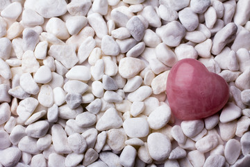 Pink heart stone on the spa stone background.