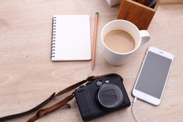 Digital camera, Smartphone with note paper and coffee on wooden