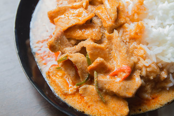 Pork in ground peanut-coconut cream curry serve with rice.