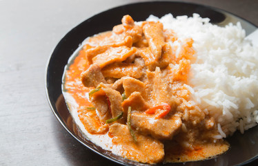 Pork in ground peanut-coconut cream curry serve with rice.