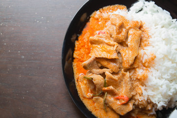 Pork in ground peanut-coconut cream curry serve with rice.