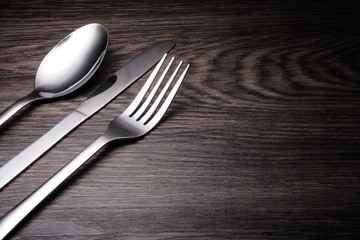 a set of cutlery on wooden background