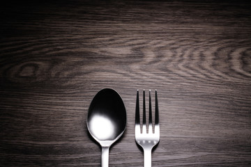 a set of cutlery on wooden background