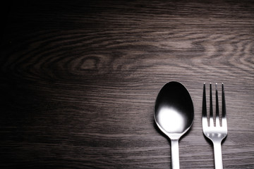 a set of cutlery on wooden background