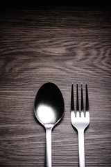 a set of cutlery on wooden background