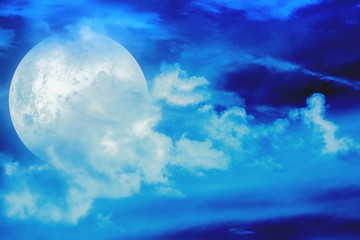 Obraz premium Moon among the clouds on a midnight sky. 