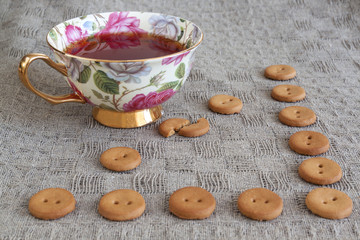 Cup of tea witn round crackers on linen 