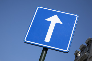 Blue and White Arrow Sign