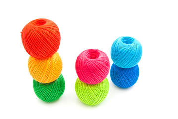many colorful balls of yarn on white