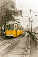 Fototapeta na wymiar yellow tram on the embankment of Budapest