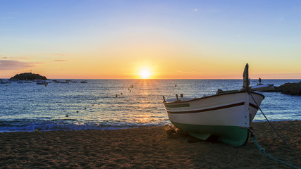 Fishing boats in the Mediterranean Sea on sunrise background