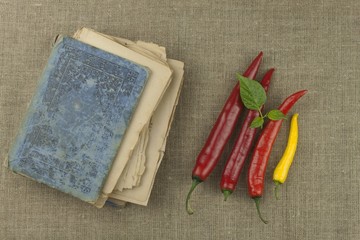 The book of old recipes. Chili peppers, ingredients for food preparation. Place for text. The menu for the restaurant.
