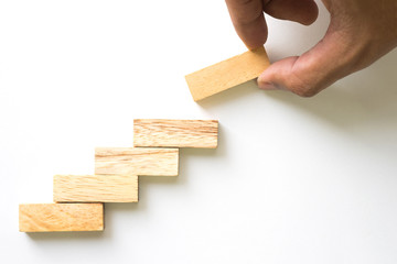 Hand aranging wood block stacking as step stair.