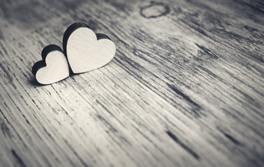 two hearts on a wooden surface