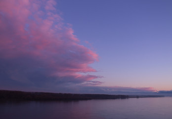 Blue sky and red clouds over the Danube river