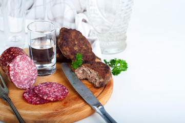 Glasses  vodka and board with sausage 