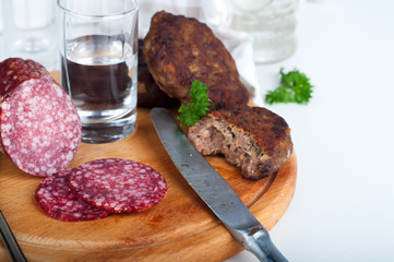 Glasses  vodka and board with sausage 