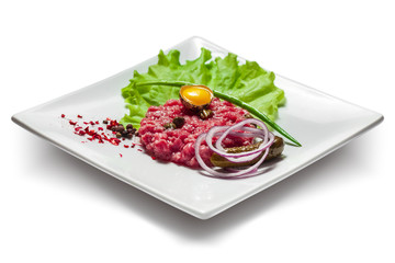 Beautiful fresh fish tartare with egg, pickles and lettuce