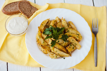 beautiful roasted potatoes with herbs and spices on a white plate