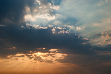 Sunrise sky with red and blue god rays