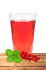 glass of juice, mint and fresh currant berries on table isolated