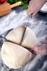 Prepering and cutting pizza dough with knife
