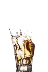 Glass of whiskey with splash, isolated on white background