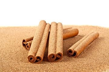 Cinnamon sticks with powder isolated on white background