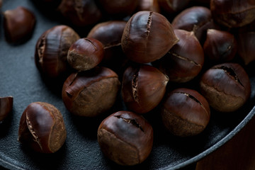 Close-up shot of roasted chestnuts in a frying pan
