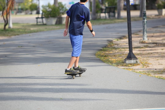 boy play skateboarding at park