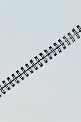 Vertical white page with diagonal black binder for background