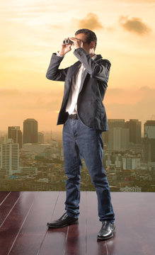 business man looking to future opportunity by binocular and usin