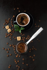 Cup of coffee, grinder and coffee beans